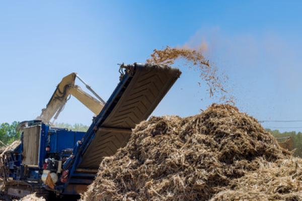 A large piece of equipment clears land ahead of a construction project